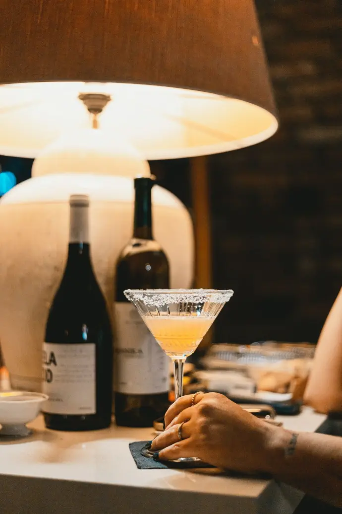 a person pouring a glass of wine